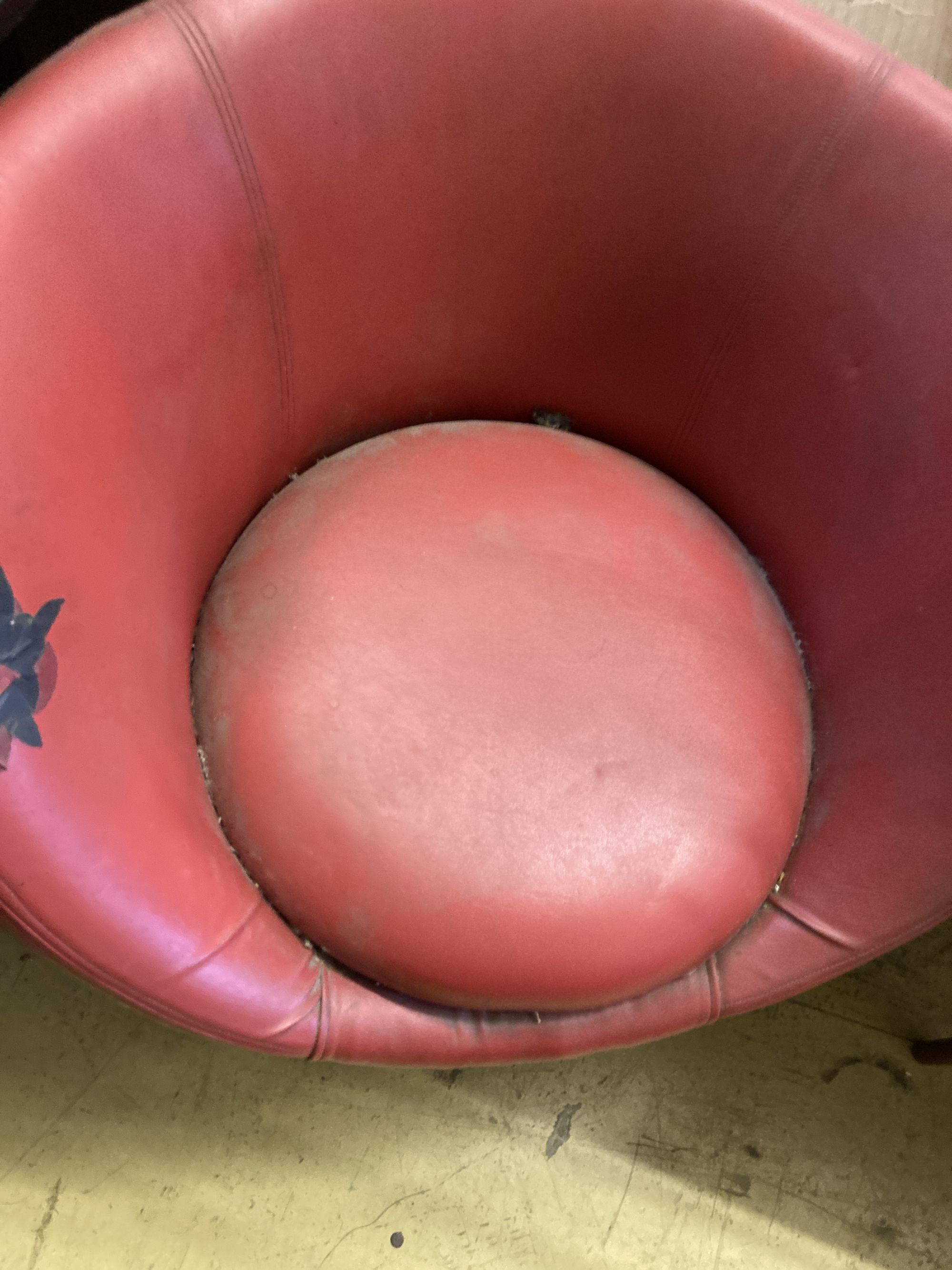 A 1970s red leatherette tub framed swivel chair, width 74cm, depth 64cm, height 74cm